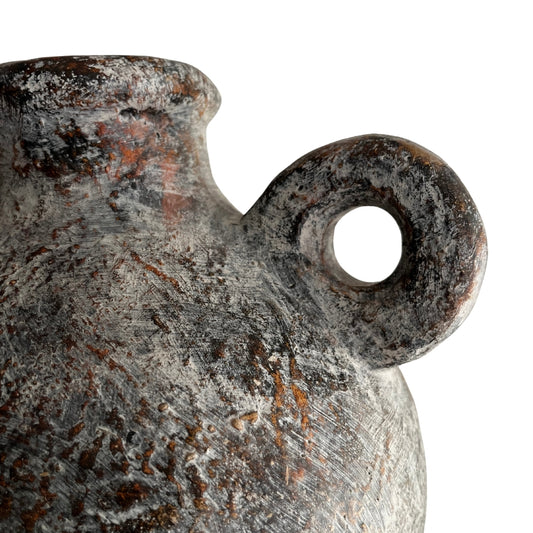 Close-up of a rustic ceramic Tanvi waterproof grey terracotta vase with a handle on a white background
