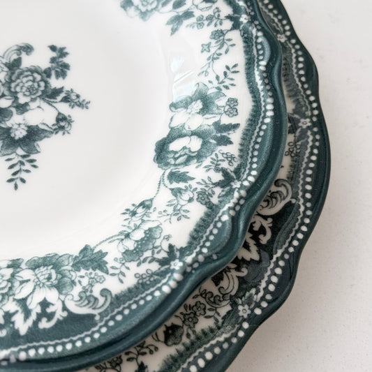 Timeless Faustine green dinner plates styled for a Christmas holiday tablescape with gold cutlery and festive decor.