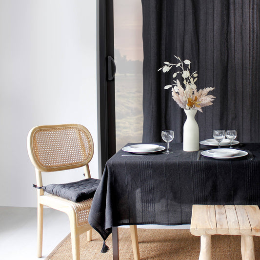 Coastal style dining table with Carbon Black tablecloth and organic modern accents