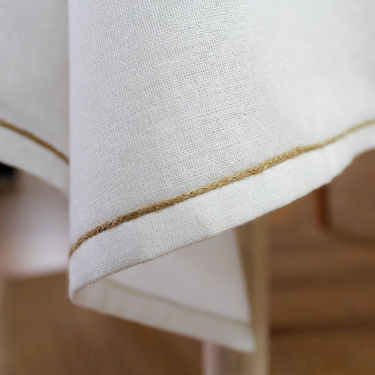 Close-up of crisp white recycled cotton texture and natural jute border detail