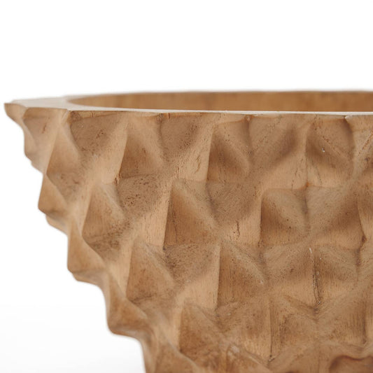 Close-up of the hand-carved durian-inspired spikes on natural teak root wood, organic modern detail.