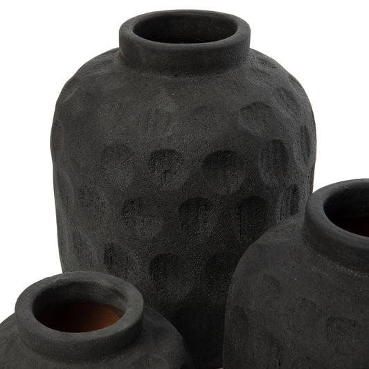 Close-up of the handcrafted contemporary pattern on black terracotta, eco-friendly artisan pottery detail.