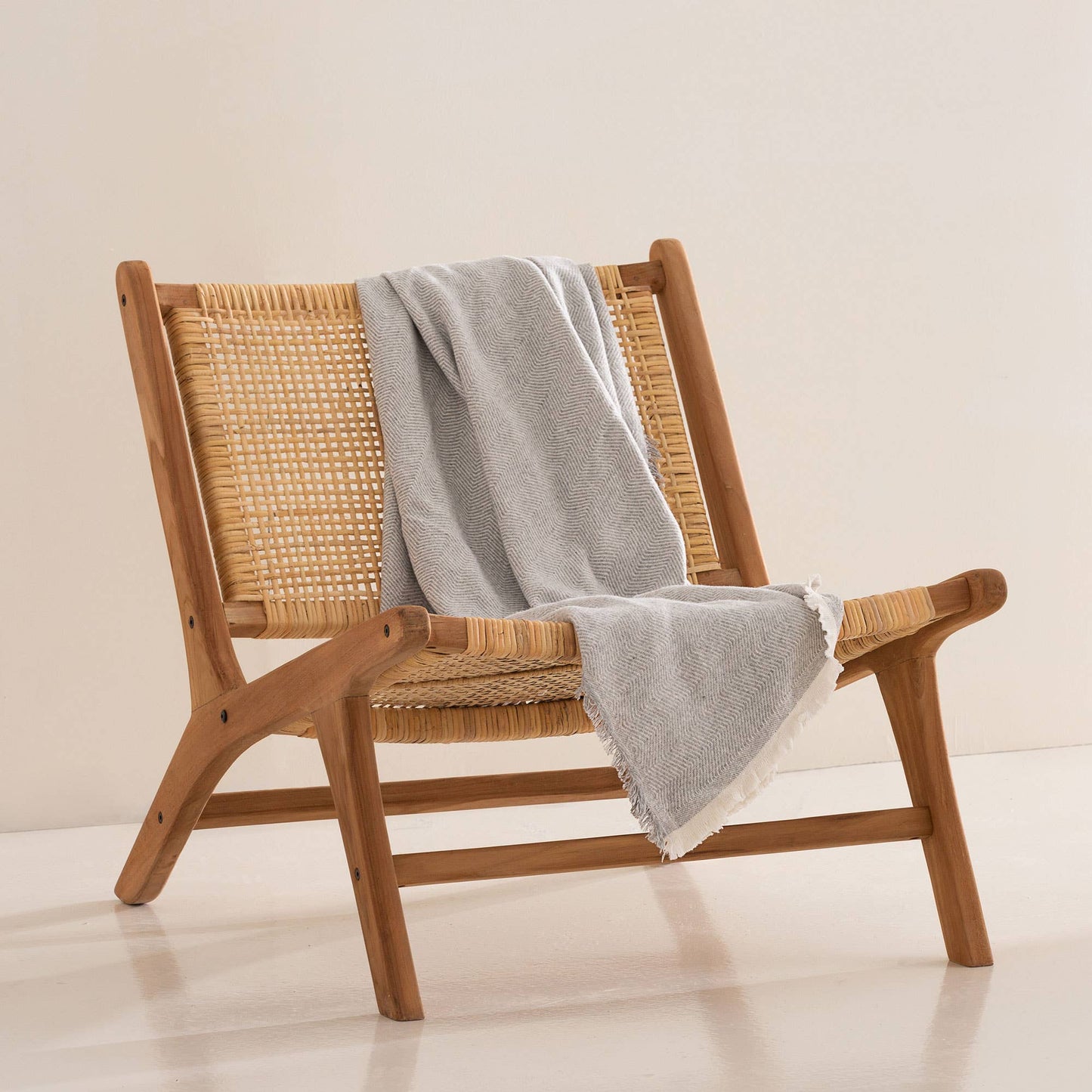 NATURE light grey cotton blanket elegantly draped over a contemporary sofa for home decoration.