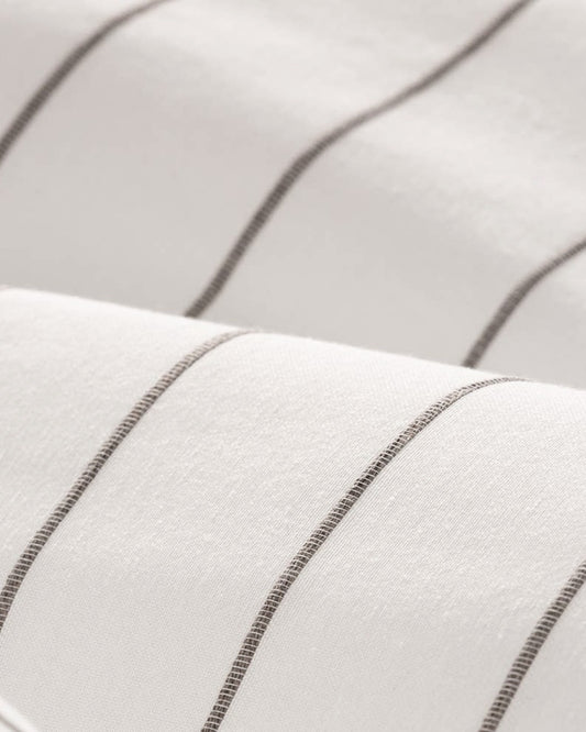 Close-up of the raised decorative jacquard weave and natural cotton texture in white and brown.