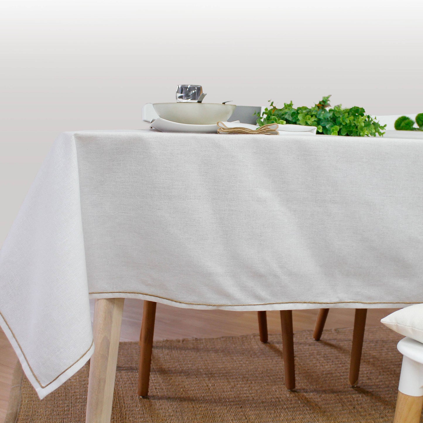 country style dining table with crisp white tablecloth and organic decor