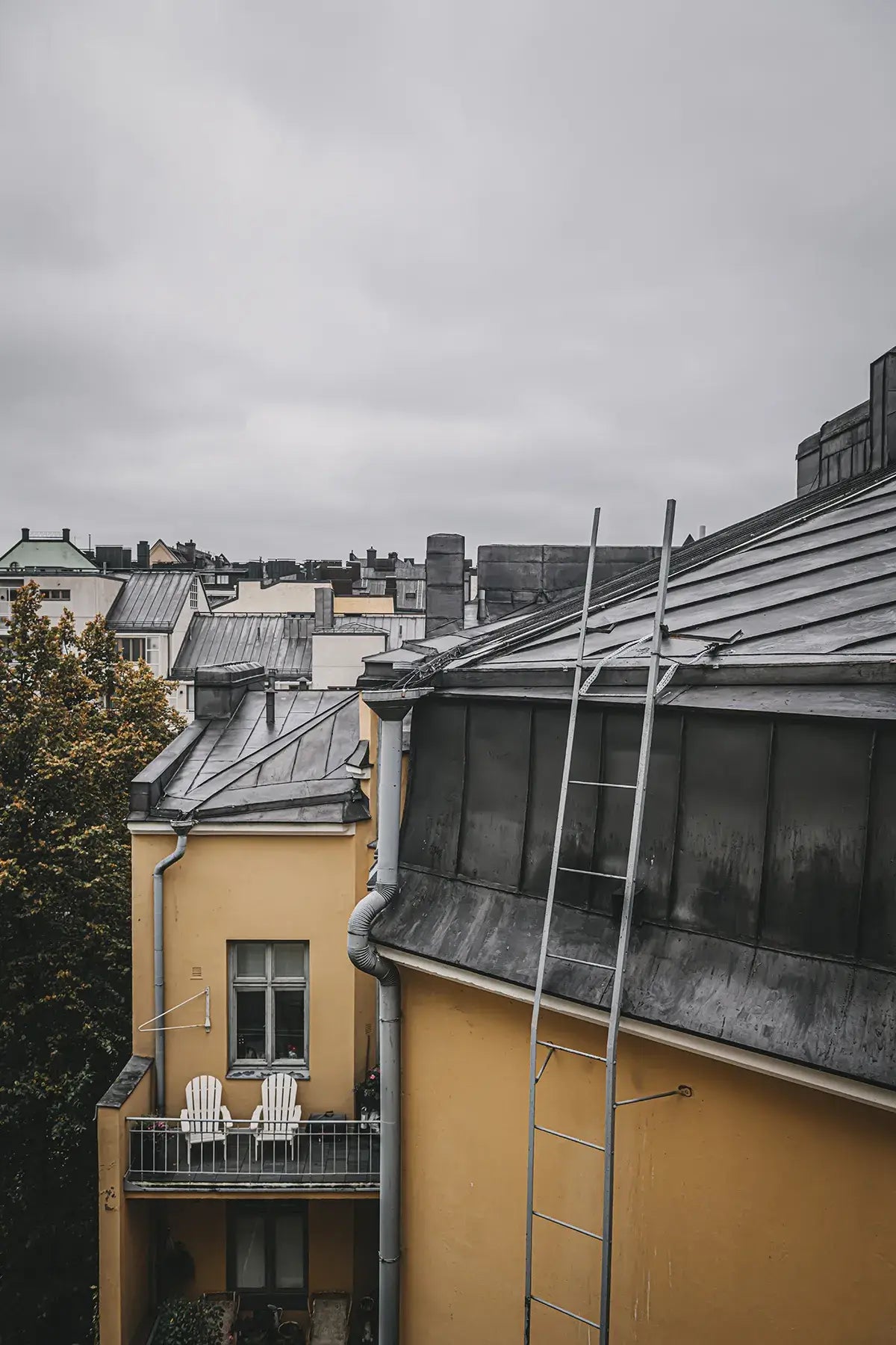 Cityscape with buildings and a ladder on a cloudy day