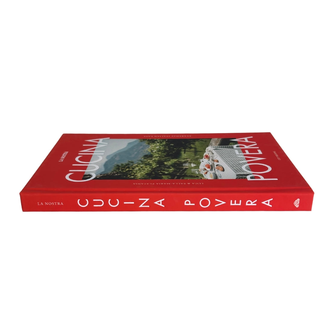 A red hardcover book titled 'Cucina Povera' by La Nuova Guizza, featuring a scenic photograph on the front cover and white lettering on the spine, set against a plain white background.