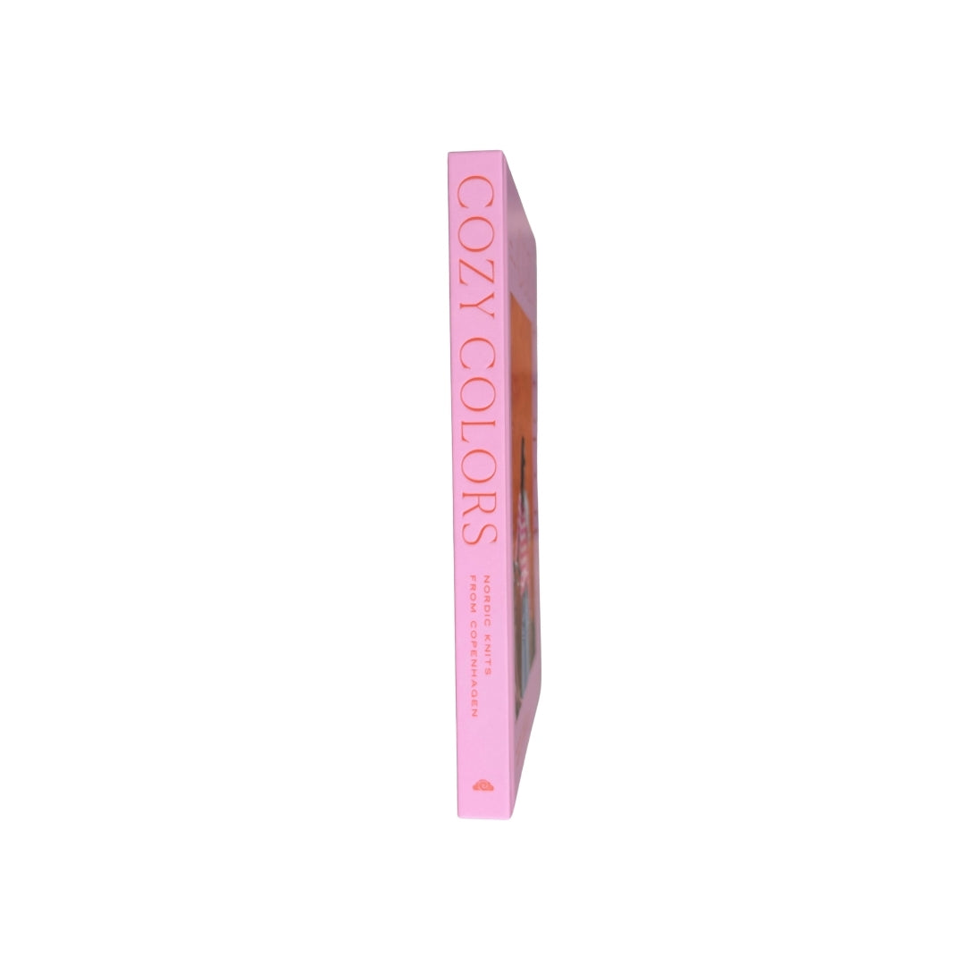 A pink hardcover book titled 'COZY COLORS' by Annie Dupont, shown standing vertically against a plain white background.