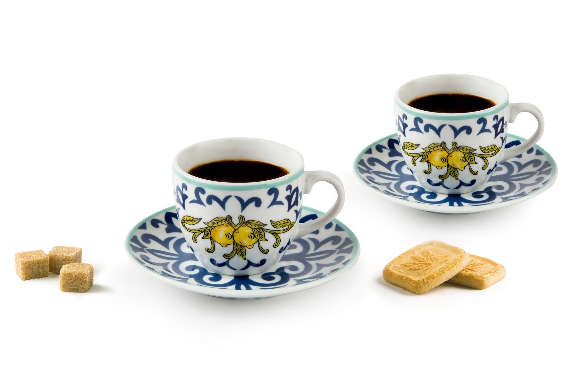 Two ceramic coffee cups with saucers featuring decorative lemon designs on a white background.