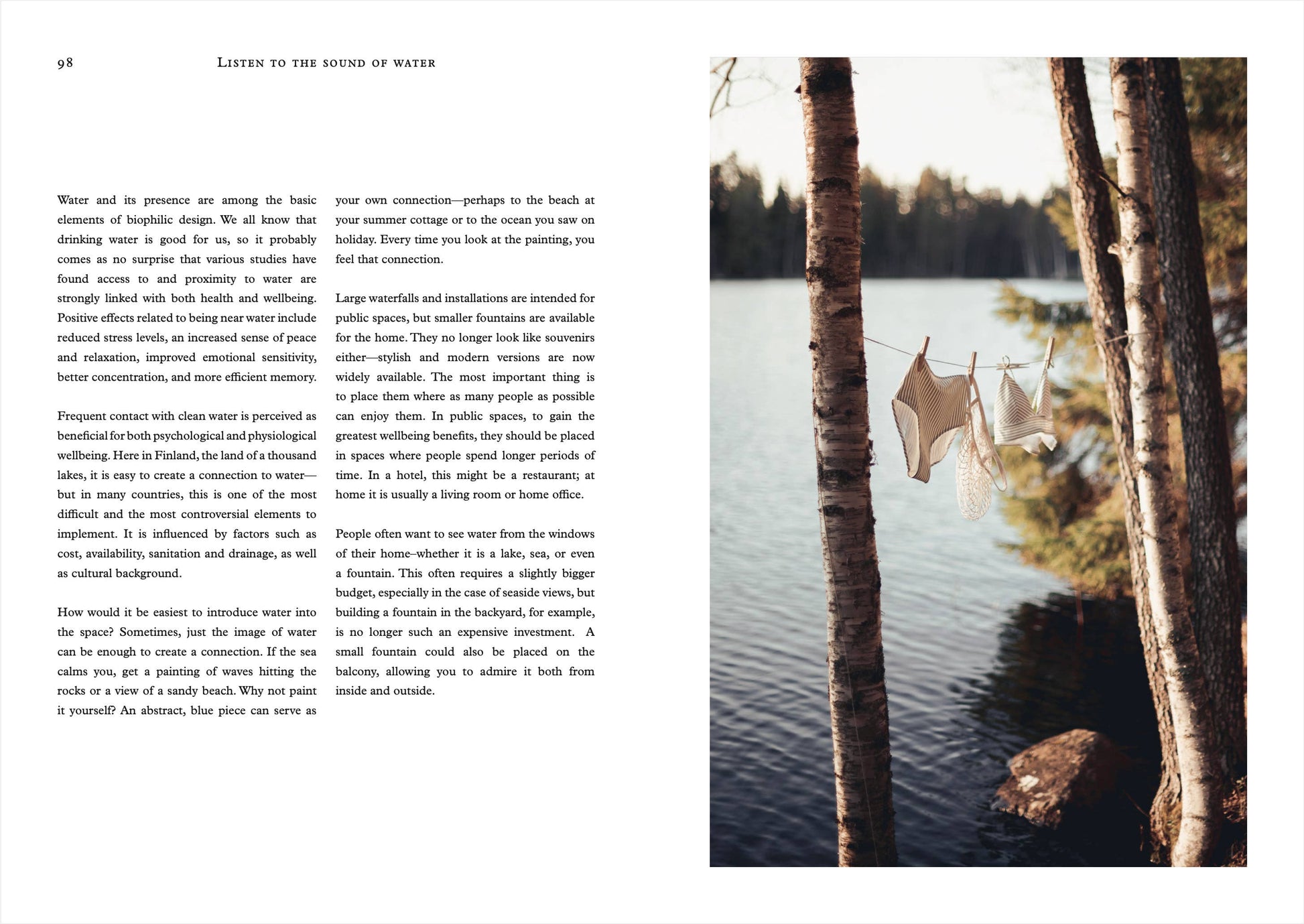 Open book with text on the left and a scenic view of a lake with trees on the right.