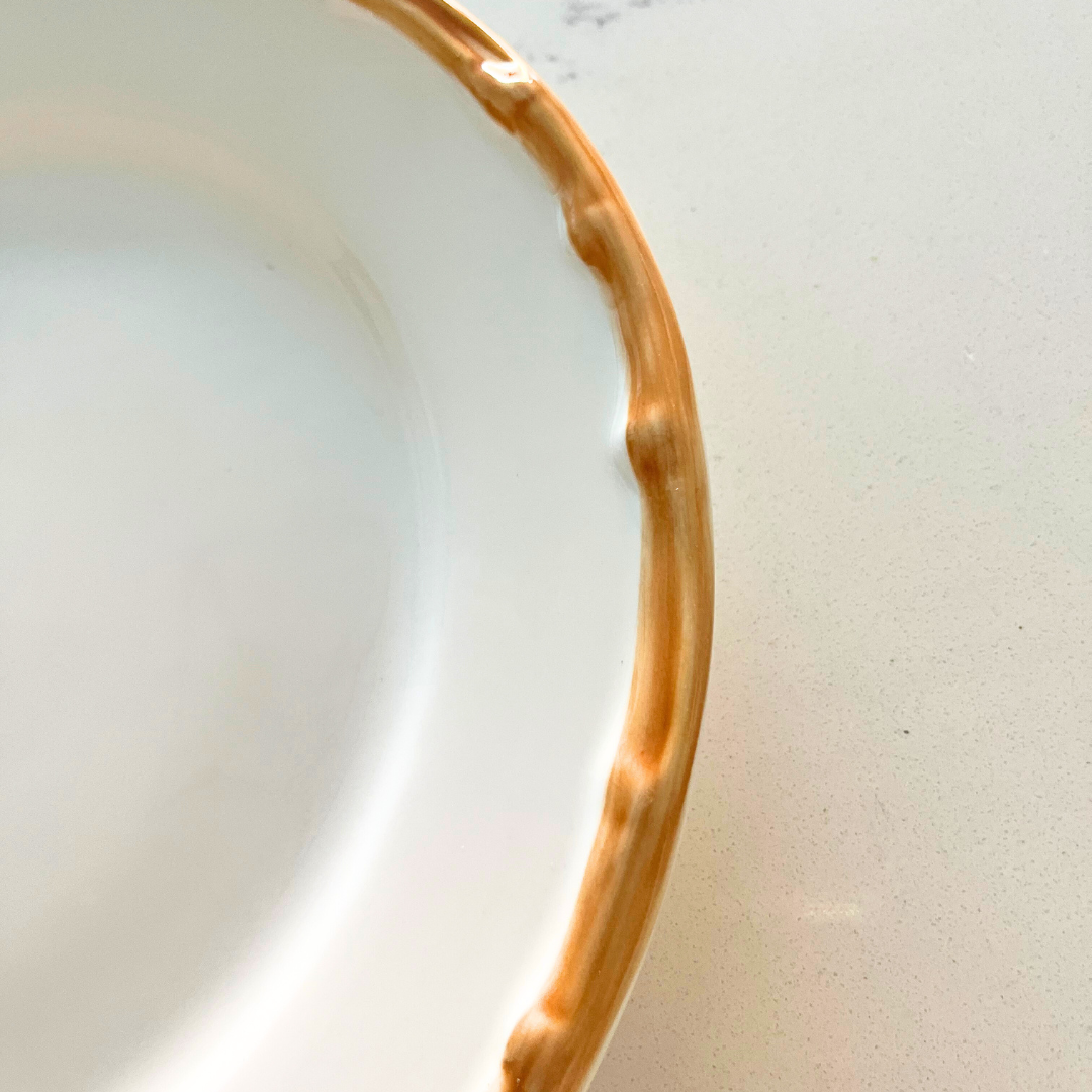 Close-up of the hand-painted effect bamboo detail on high-quality white porcelain dinner plate.