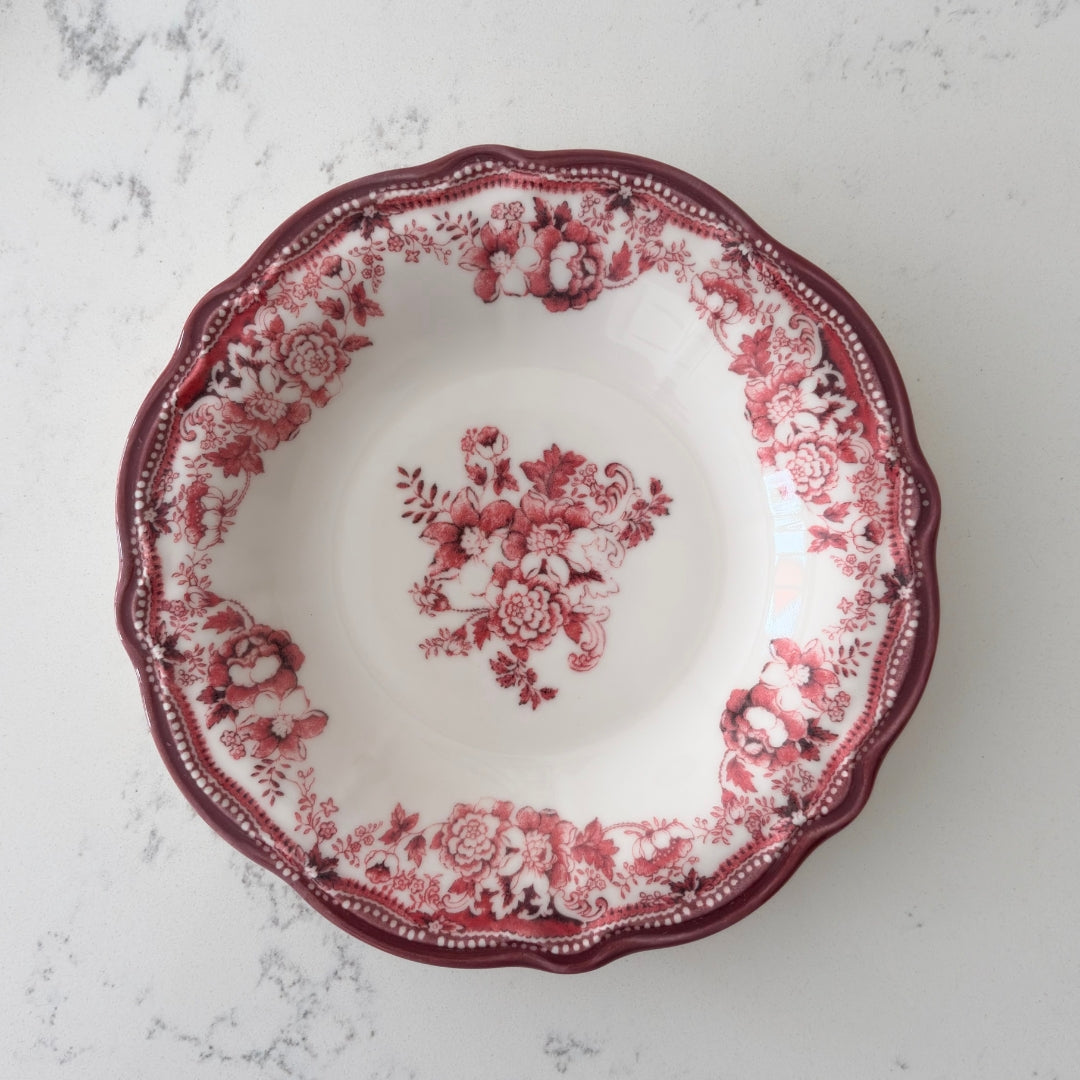 Deep pasta plates in antique red-pink styled with gold accents for a romantic Bridgerton-style dinner.  Deep pasta plates in antique red-pink styled with gold accents for a romantic Bridgerton-style dinner.