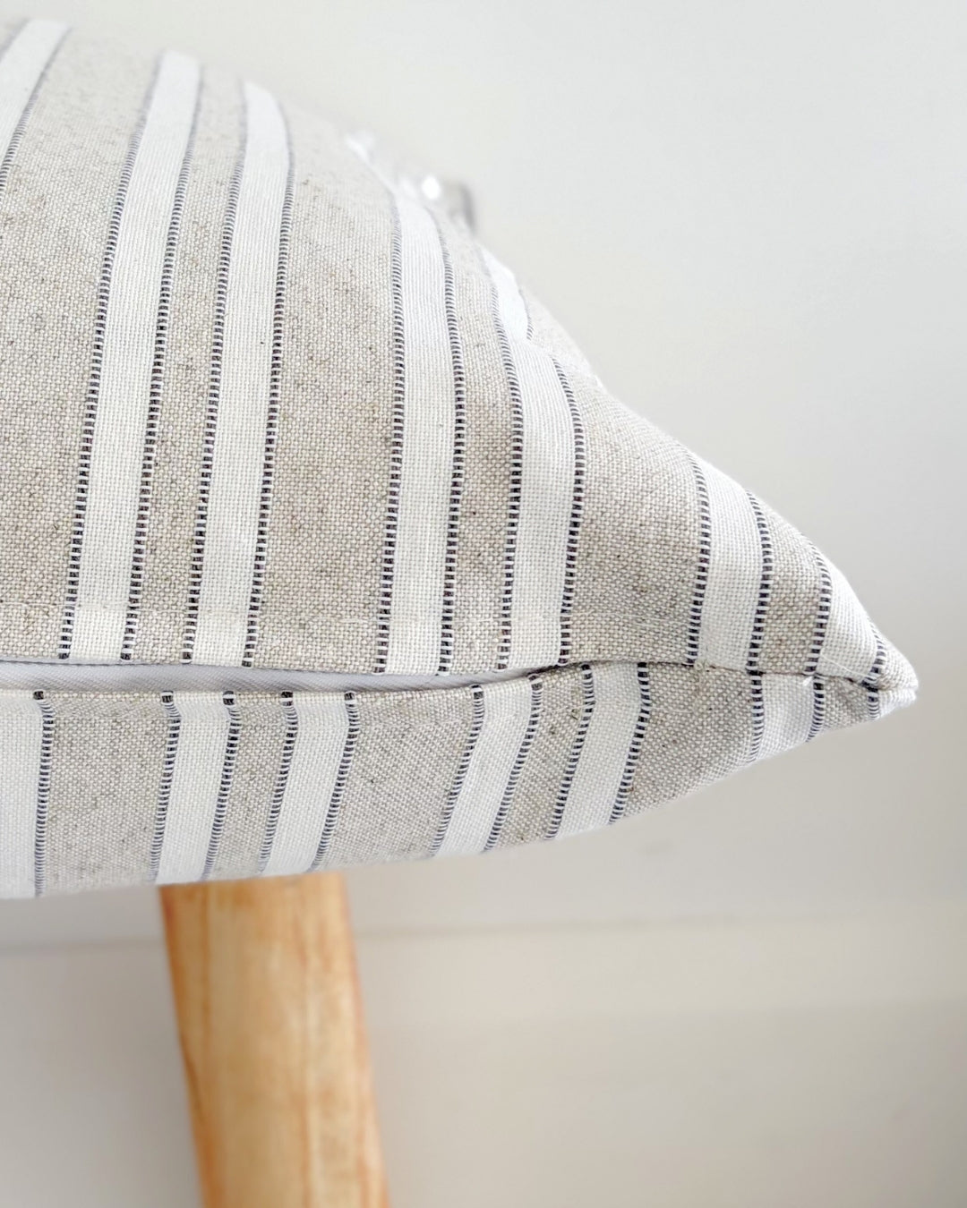 Close-up of the high-quality hidden zipper closure on an earthy taupe jacquard cushion cover.