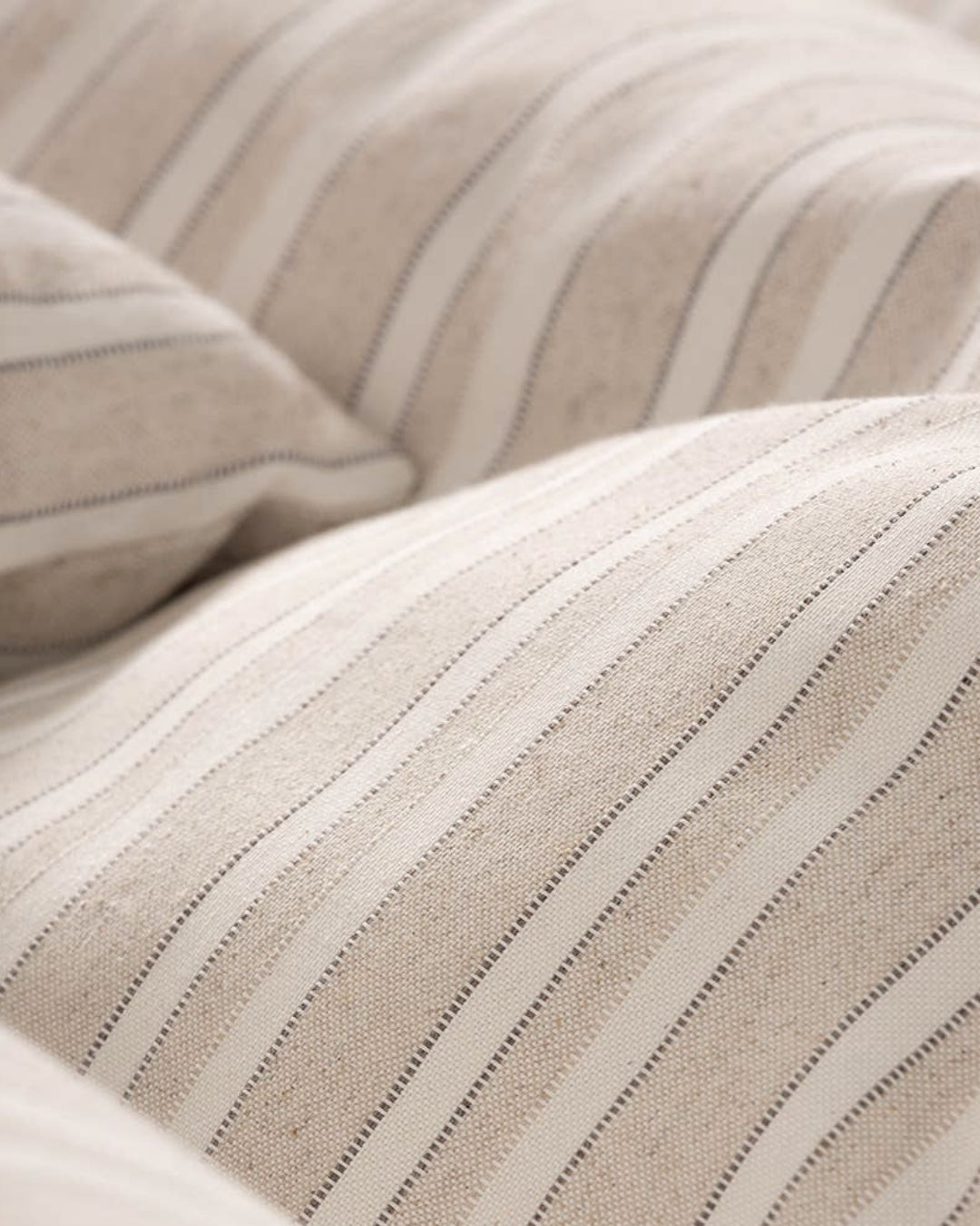 Premium taupe jacquard weave showing the depth and character of the raised decorative finish and real cotton feel.