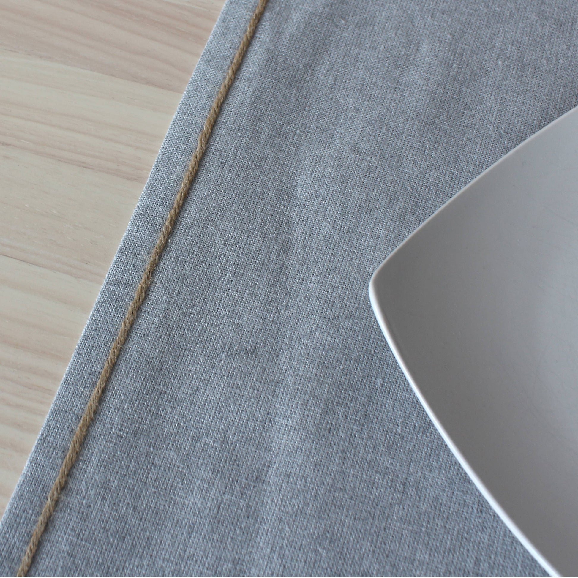 Specialized water repellent effect on a silver grey table runner showing liquids beading on the unique textured surface.