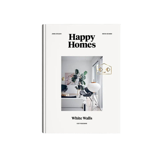 A hardcover book titled 'Happy Homes White Walls' by John Richards and Kevin Hennes, featuring a minimalist white cover with a central interior design photograph.