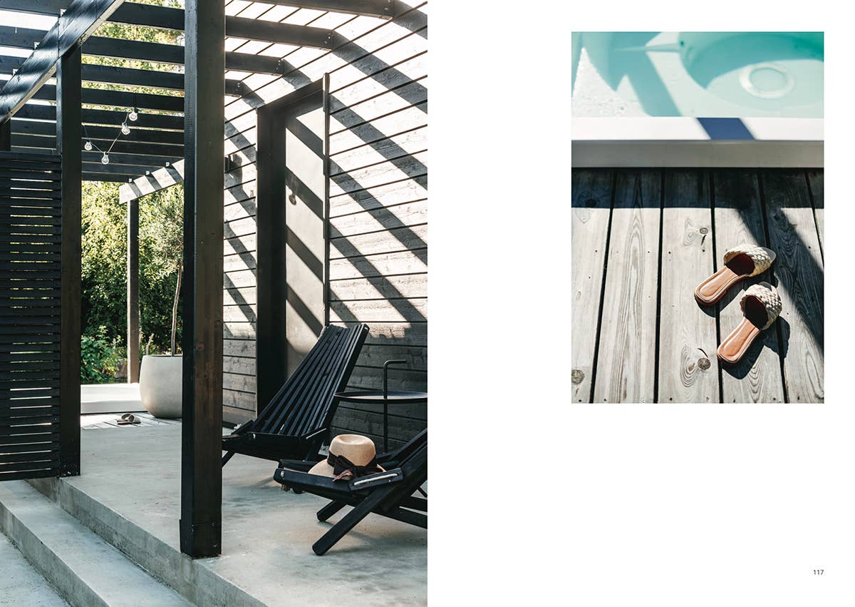 Modern outdoor setting with a black chair and open wooden structure.