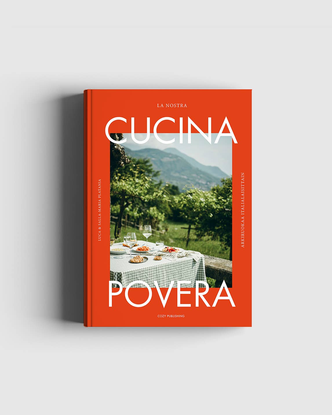 Book titled 'Cucina Povera' with an image of a table outdoors on the cover.