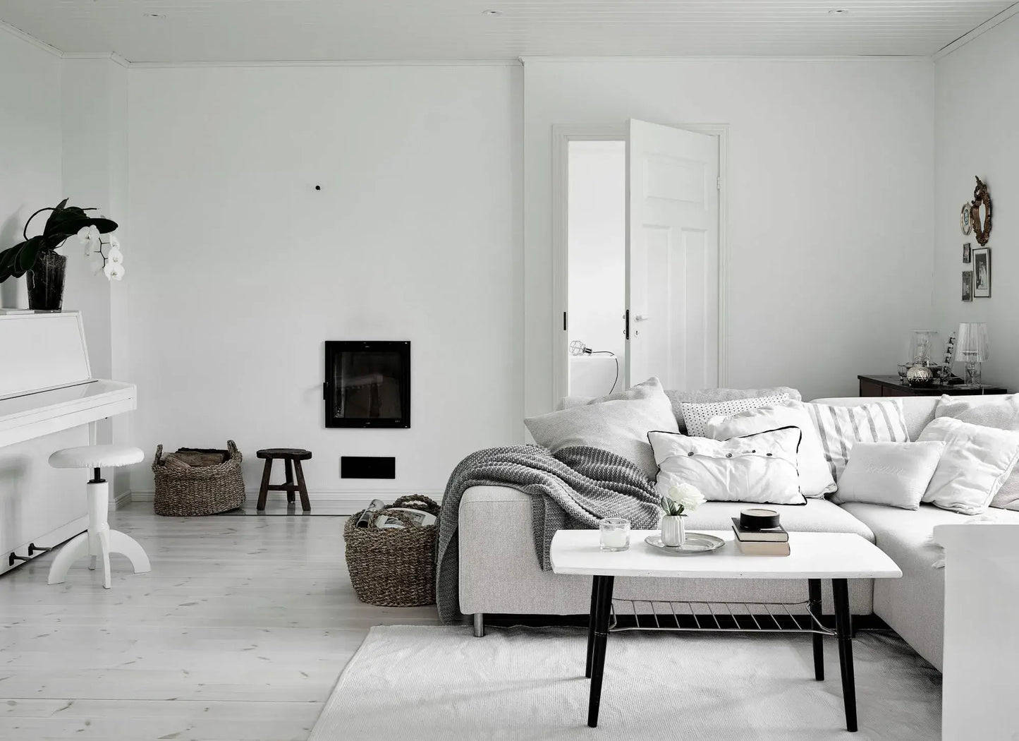 Modern living room with white walls, furniture, and decor.