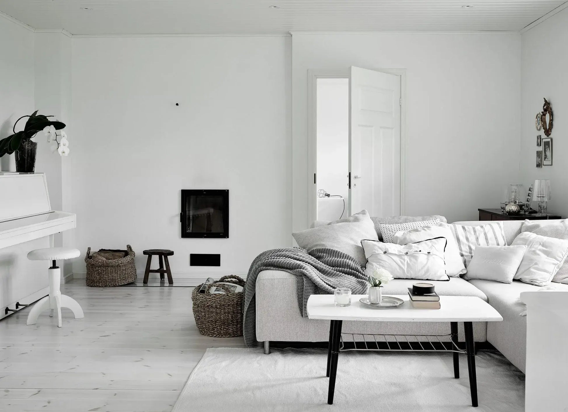 Modern living room with white walls, furniture, and decor.