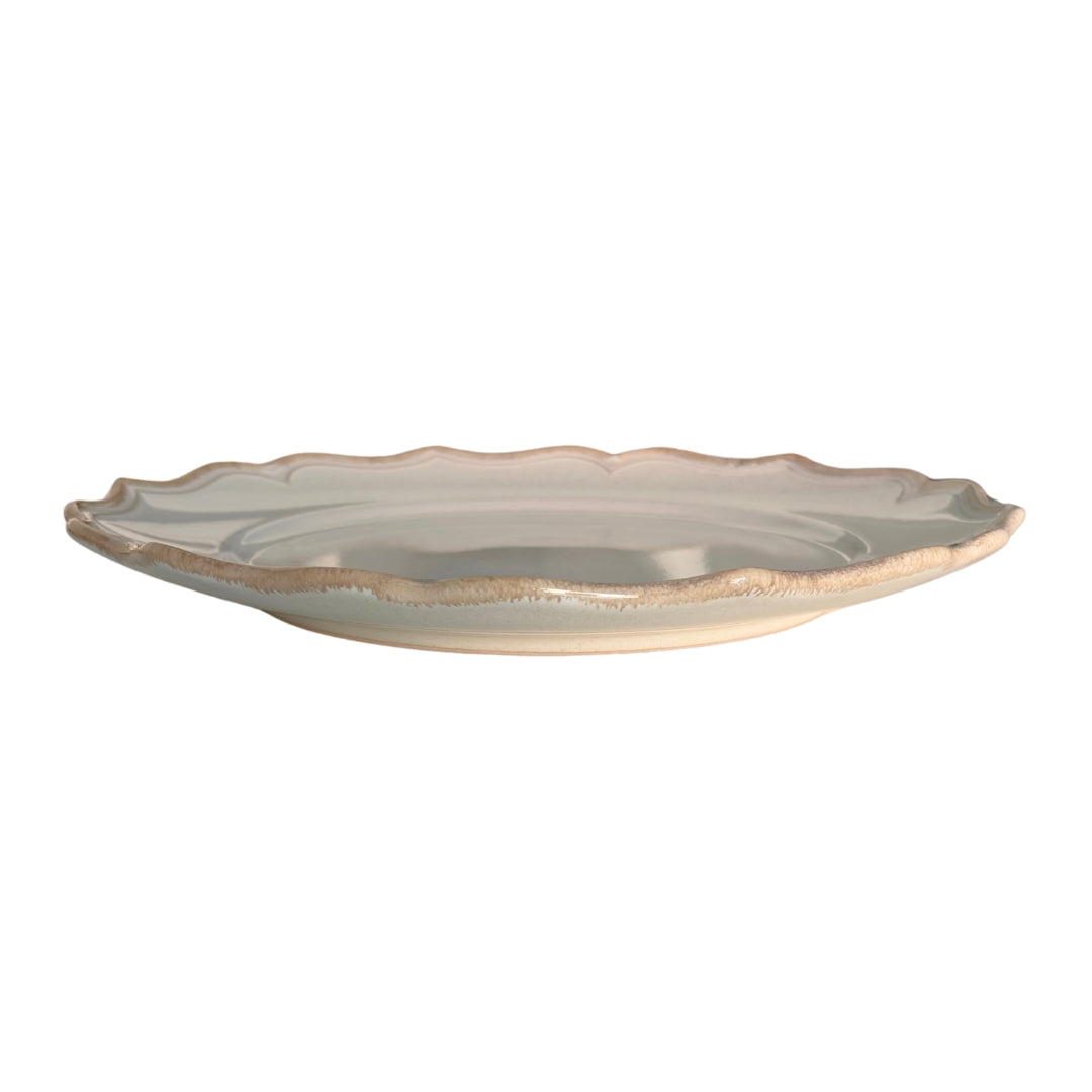 Side view of beige stoneware dessert plate showing its raised profile
