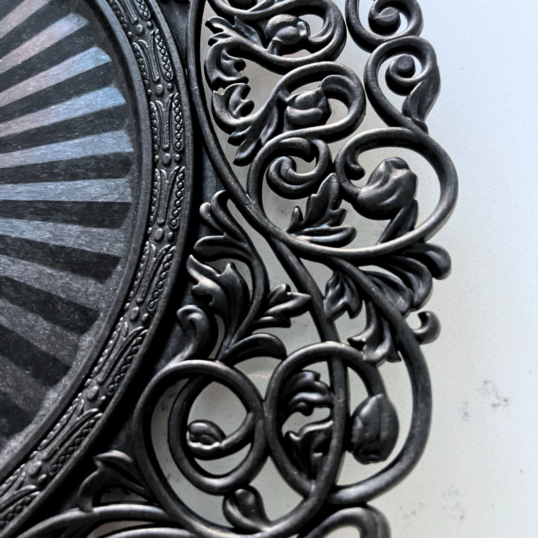 Black Baroque charger plate styled with a white dinner plate for elegant table decor