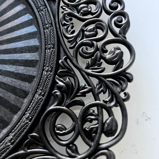 Black Baroque charger plate styled with a white dinner plate for elegant table decor
