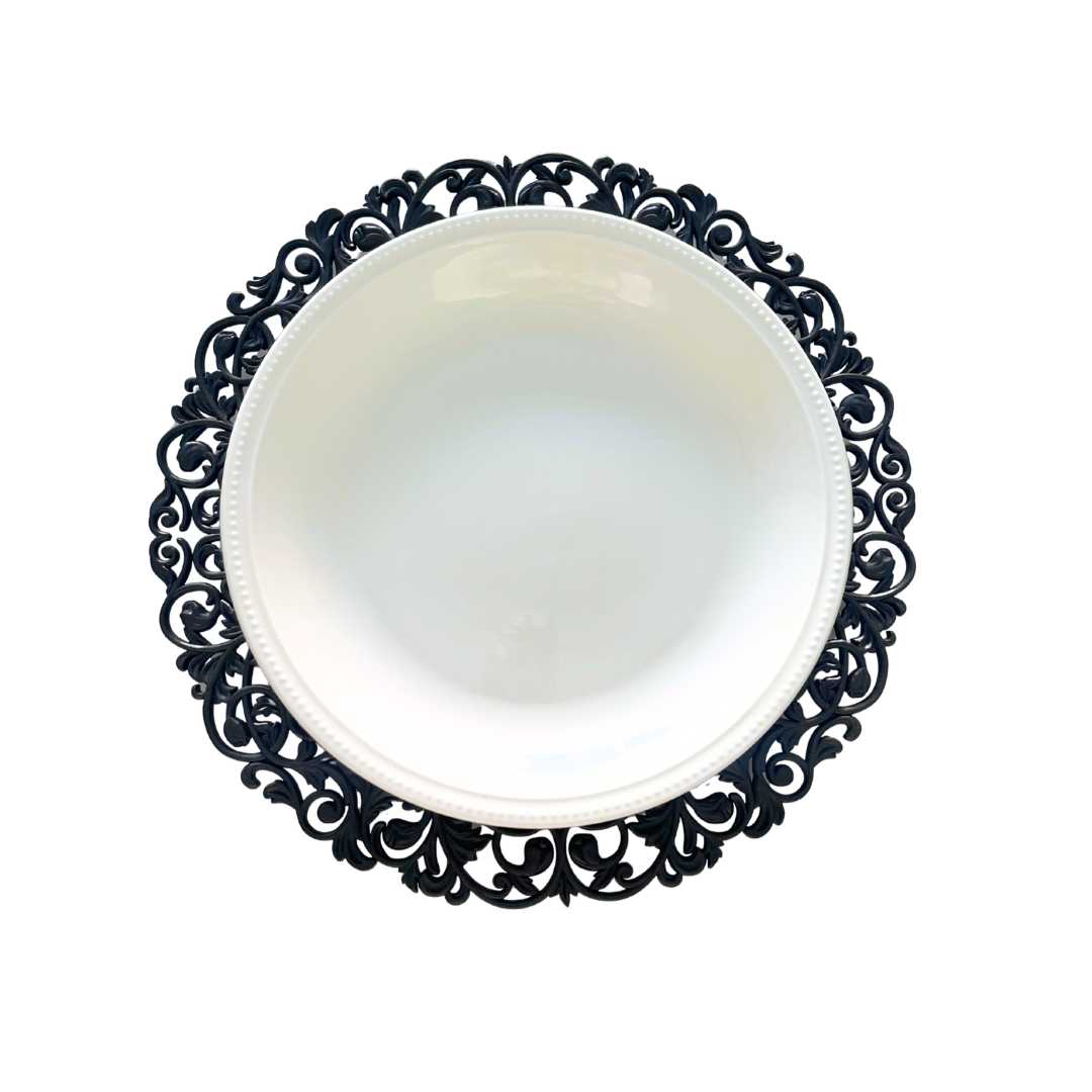 Round black Baroque charger plate featuring an elaborate decorative border