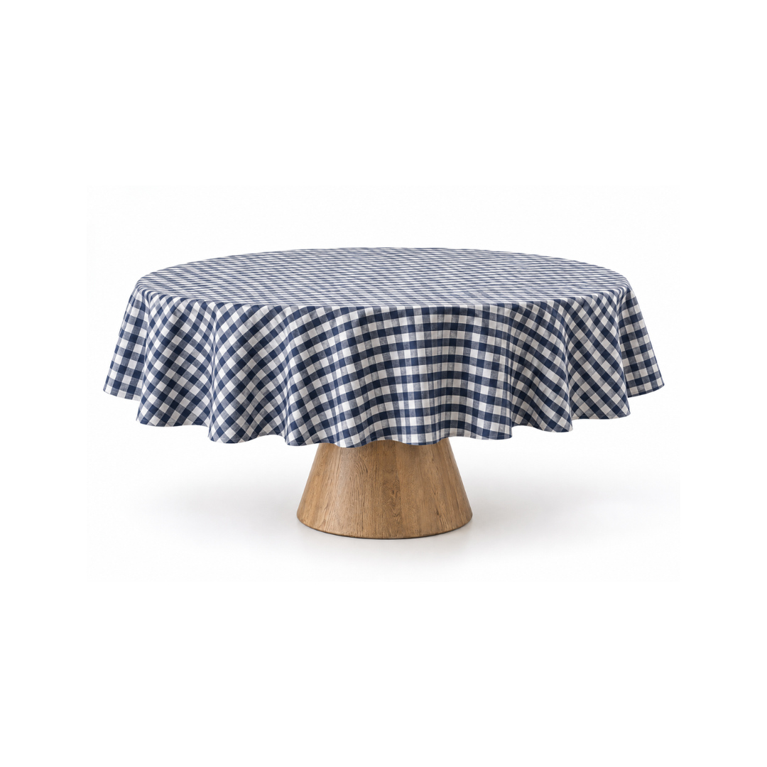 Blue gingham round tablecloth styled on a wooden pedestal dining table