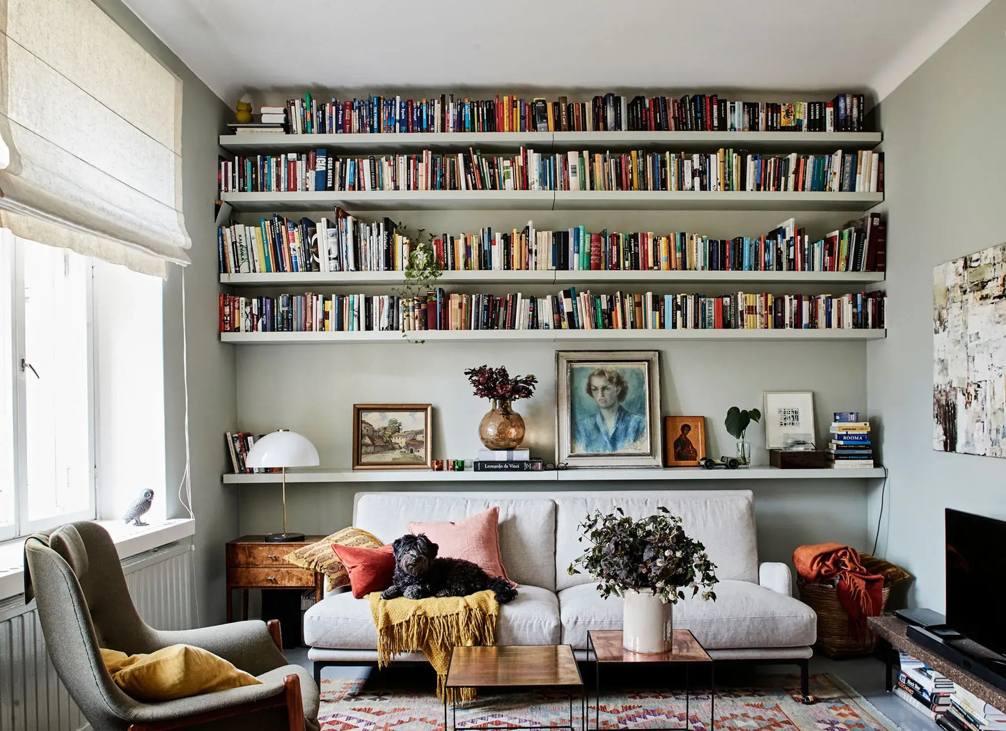 Living room with bookshelves, sofa, and decorative items