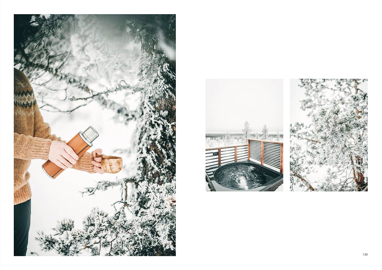 Person holding a smartphone with snowy landscape, hot tub, and tree.
