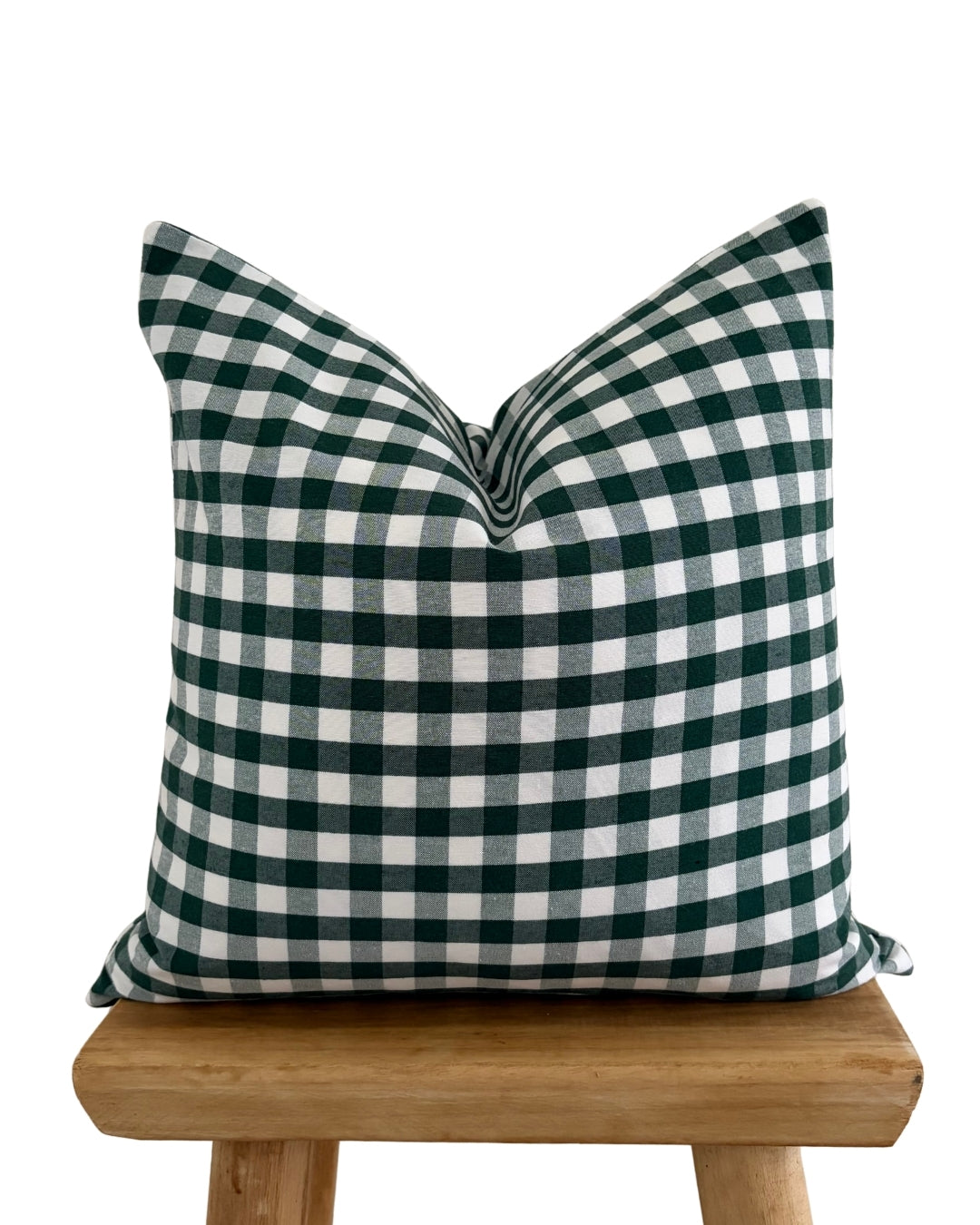 forest green gingham cushion cover on raw wood stool.