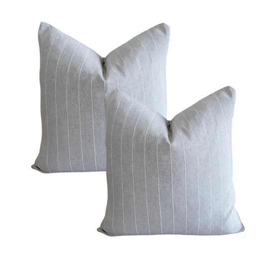 Set of two grey cushion covers with fine white pinstripe jacquard lines.