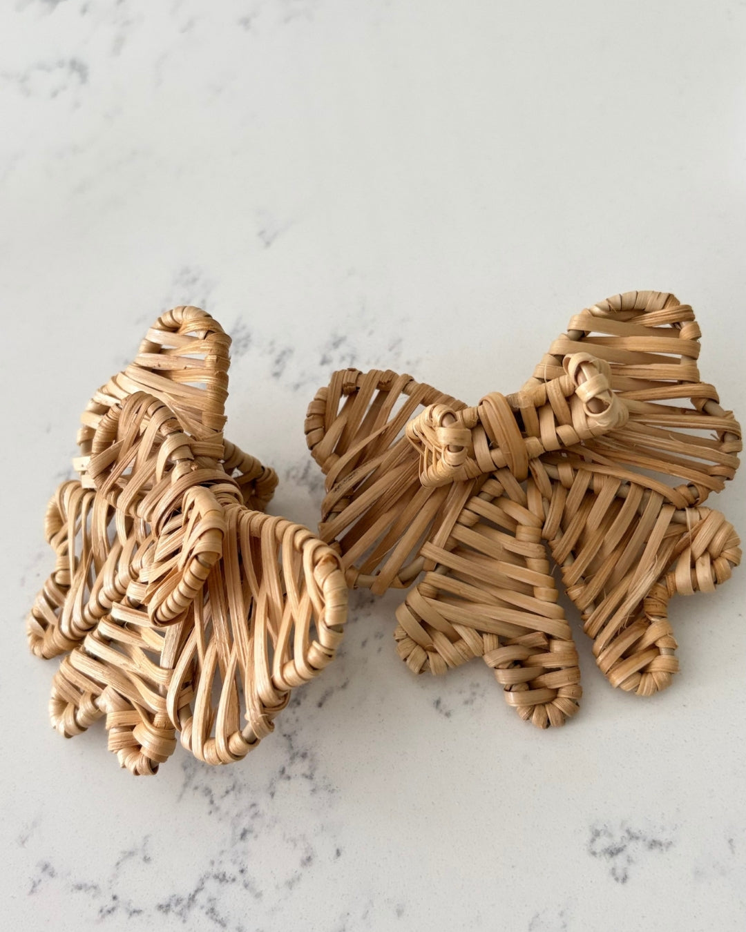 Two handwoven Double Bow Rattan Napkin Rings showing natural variations in the artisan weave