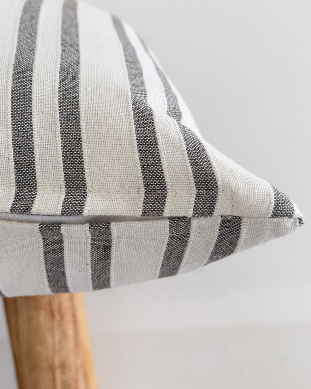 Discreet zipper closure on an elegant taupe textured cushion taupe