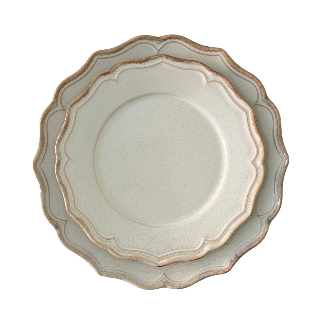 Layered beige stoneware plates with elegant scalloped edges