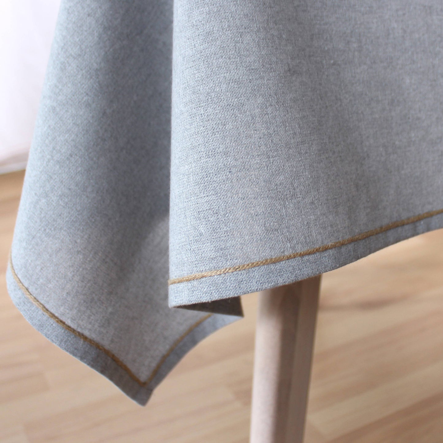 Detail of lgrey recycled cotton texture and natural jute festoon border
