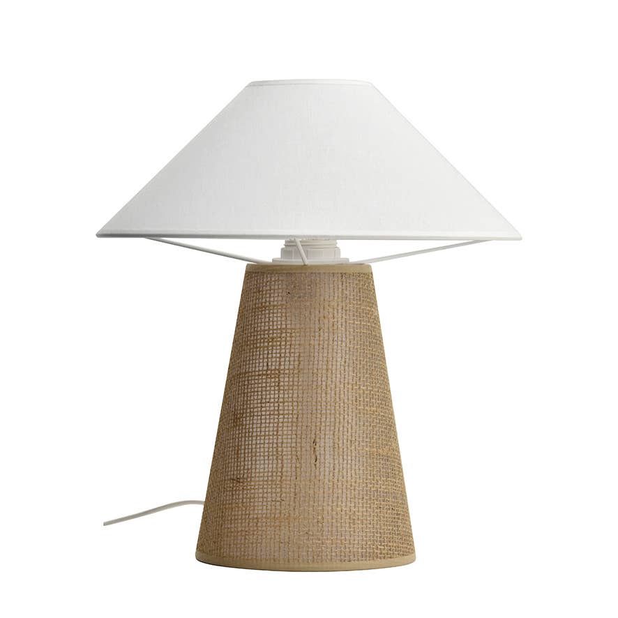 Sculpt artisan lamp styled on a wooden nightstand in a Mediterranean-inspired bedroom.