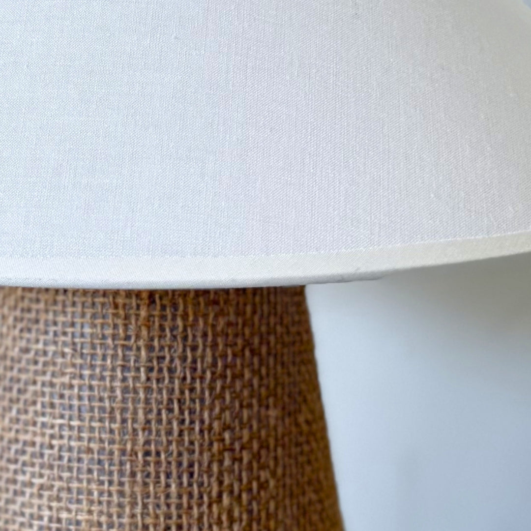 Flat lay display of premium raw cotton fabric and natural sisal fibers used in the Sculpt lamp.
