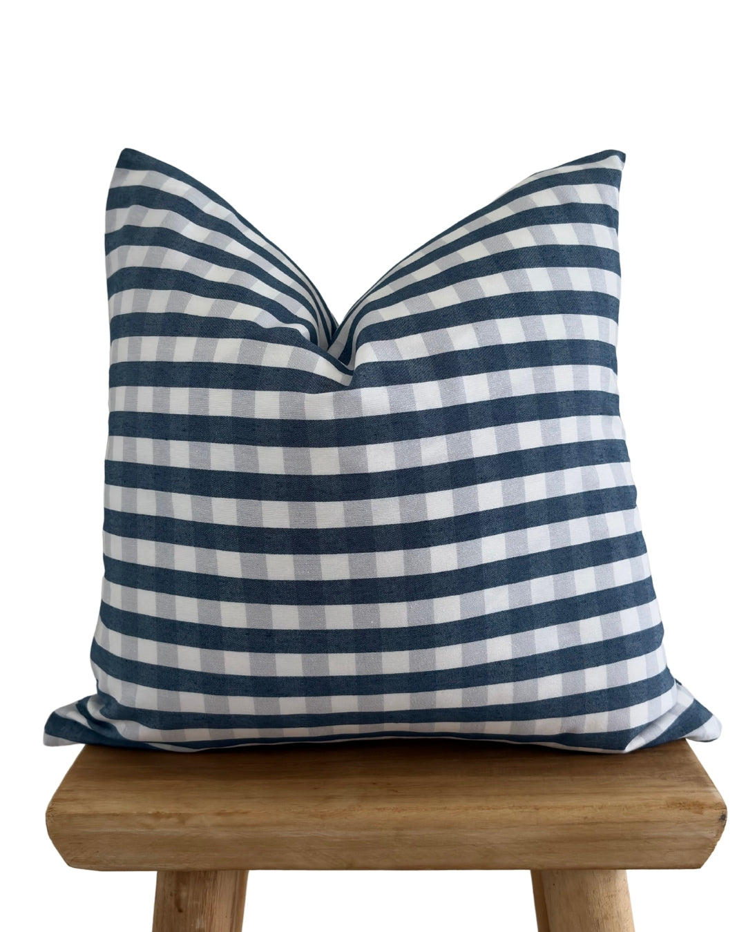 navy blue gingham cushion cover with wood stool.