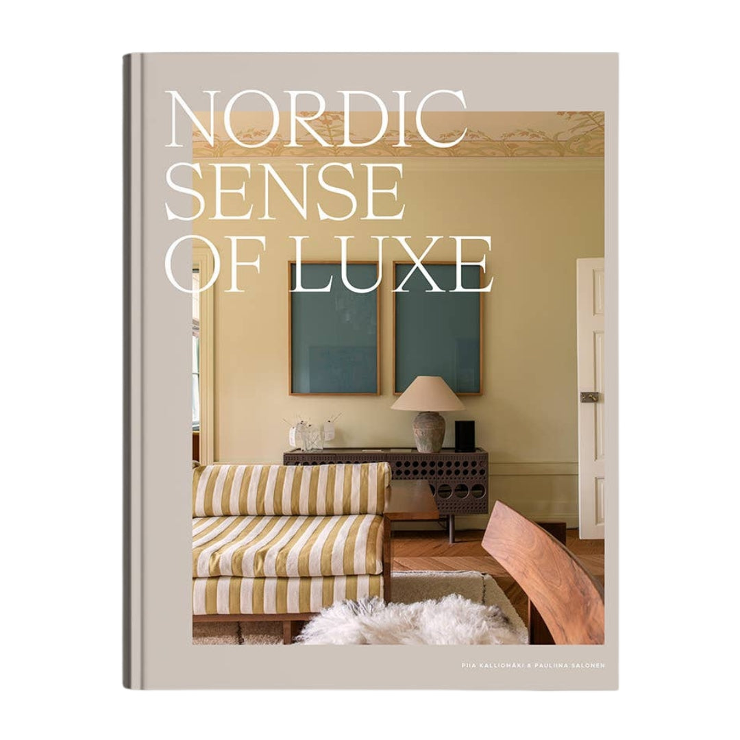 A hardcover book titled 'Nordic Sense of Luxe' by Kim Kalilander and Petra Salander, featuring a warm beige cover with a photograph of a cozy, minimalist living room.