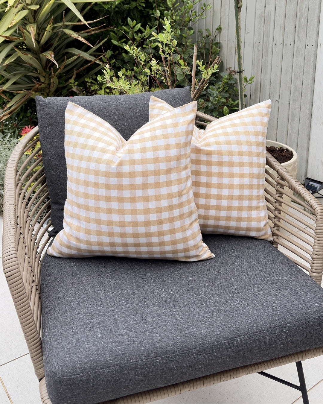 Outdoor garden armchair styled with beige splash-proof gingham cushions