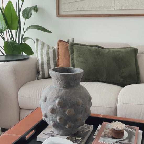 Textured terracotta indoor/outdoor vase styled in a modern living room.