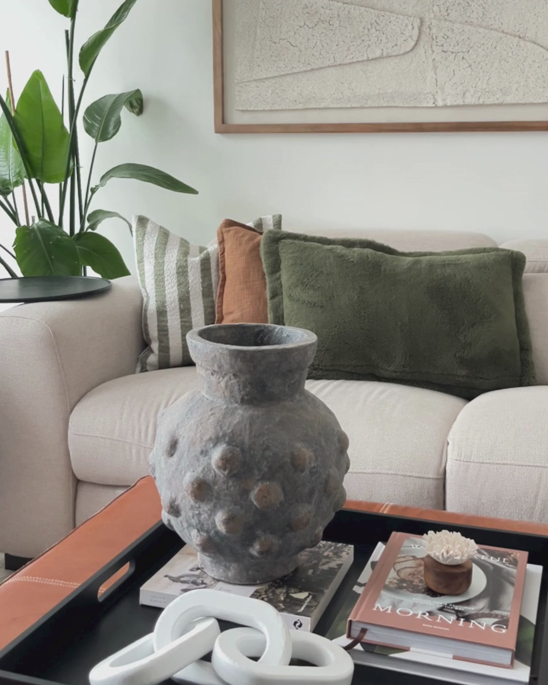 Textured terracotta indoor/outdoor vase styled in a modern living room.