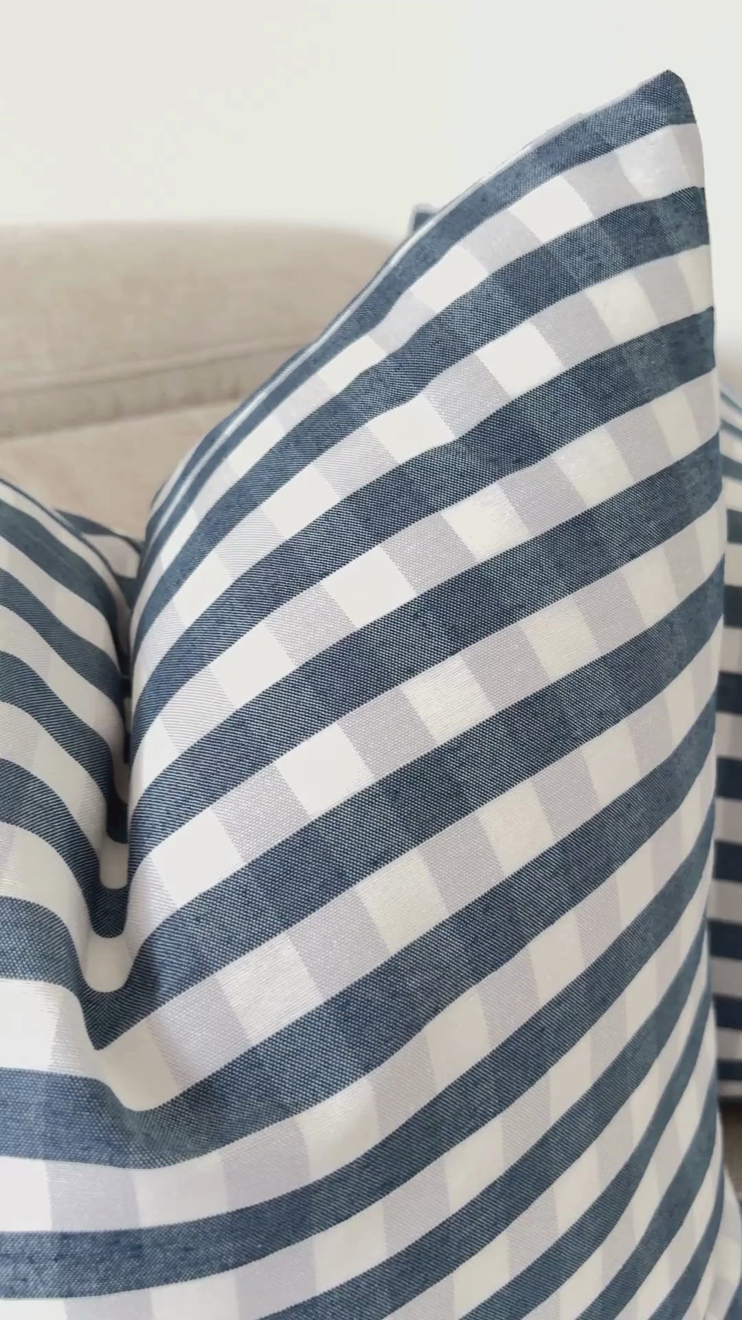 Demonstration of splash-proof water repellent finish on navy blue gingham cushion cover.