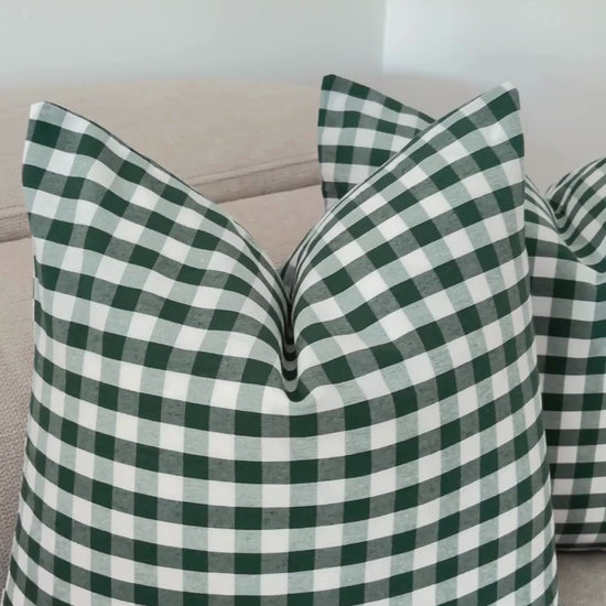 Demonstration of splash-proof water repellent finish on perfect Christmas green gingham cushion cover.