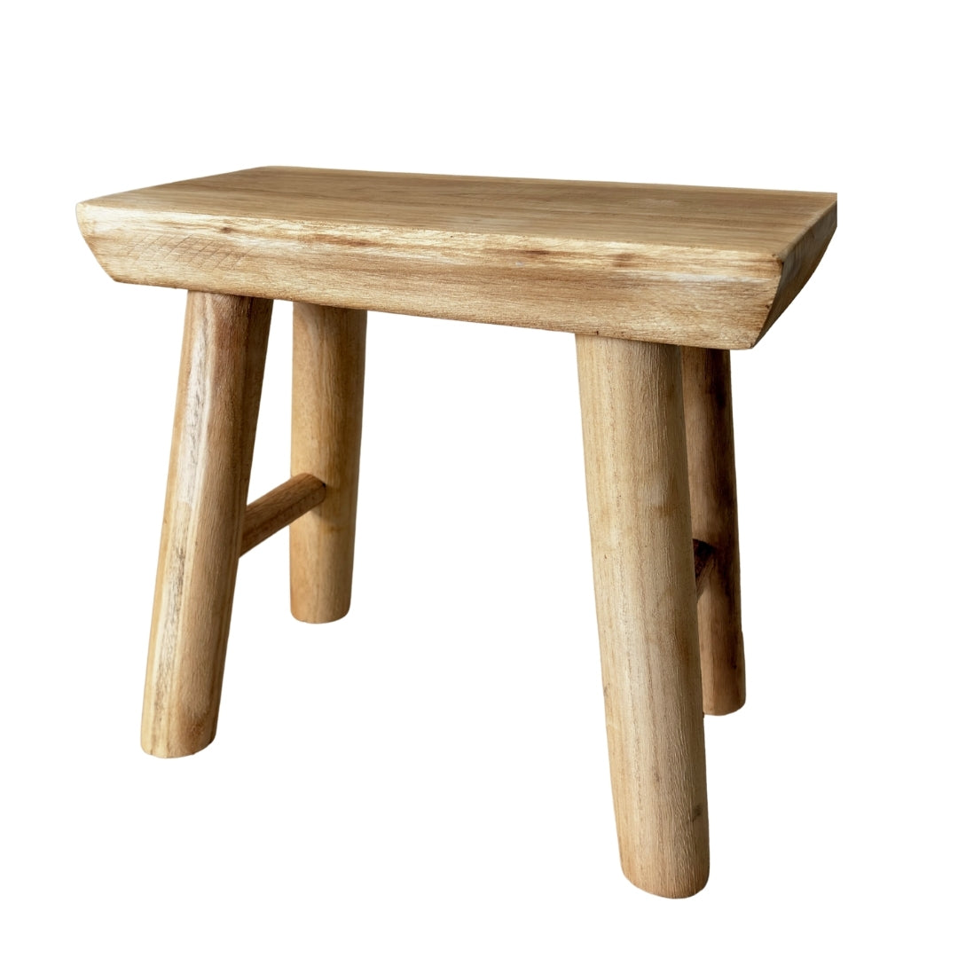 Handcrafted raw wood artisan stool made from solid timber with natural grain.