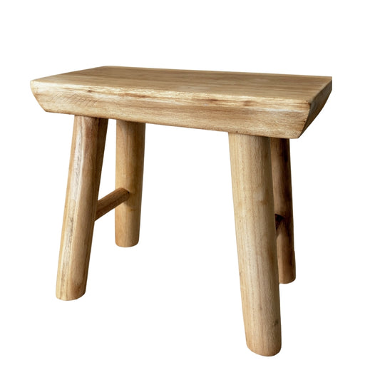 Handcrafted raw wood artisan stool made from solid timber with natural grain.