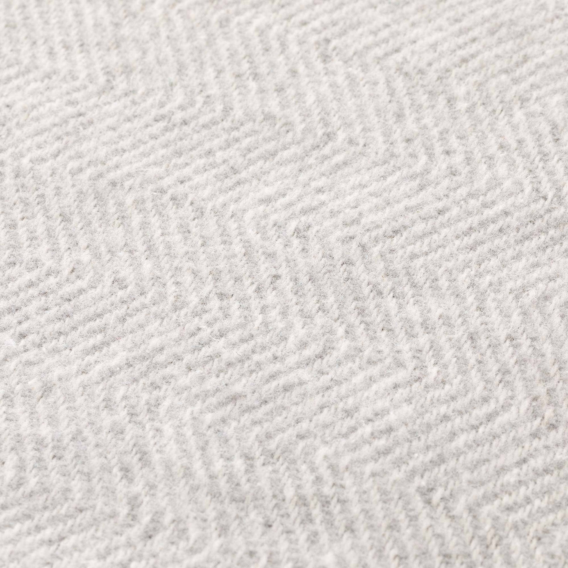 Close-up of the breathable and soft natural cotton fabric texture of the NATURE collection blanket.
