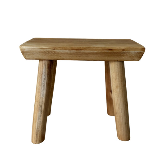 Close-up of unique cracks and natural wood textures on a handcrafted artisan pedestal.